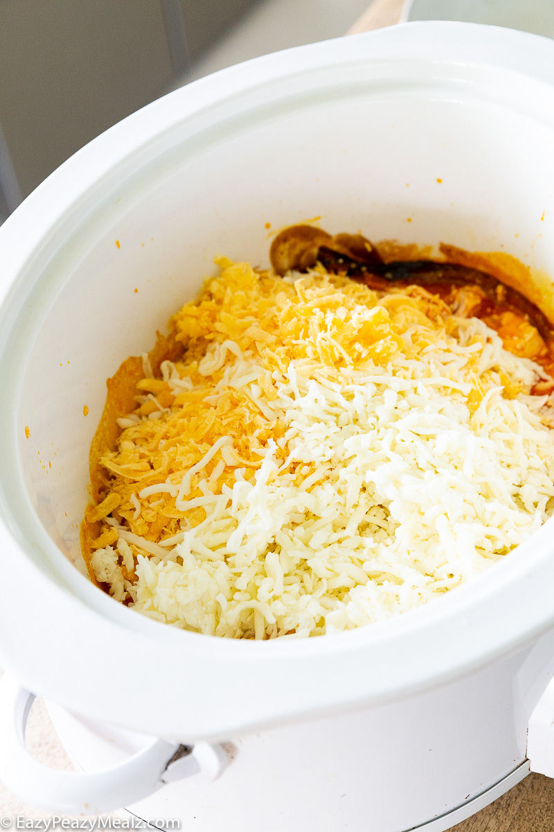 adding cheese to the buffalo chicken mac and cheese