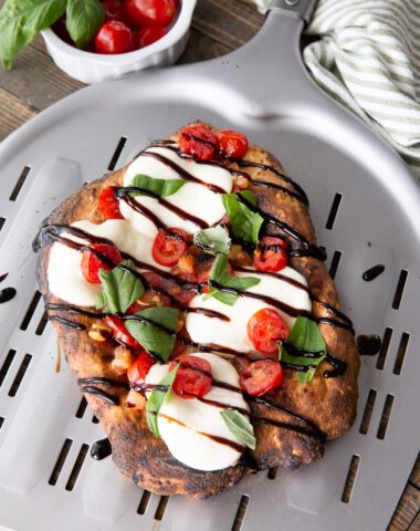 A caprese flatbread, a delicious and simple flatbread made in a pizza oven.