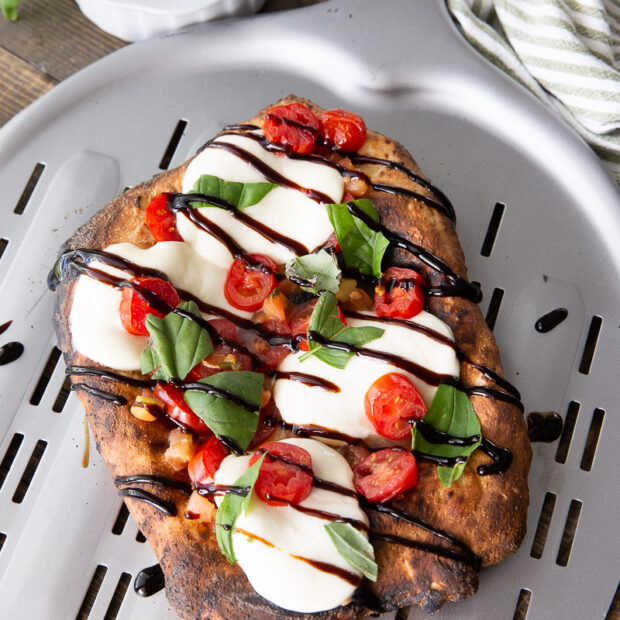 A caprese flatbread, a delicious and simple flatbread made in a pizza oven.