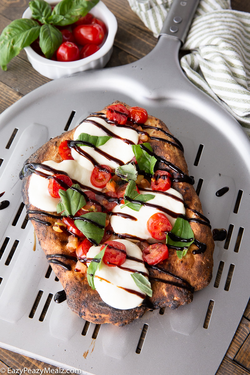 A caprese flatbread, a delicious and simple flatbread made in a pizza oven.