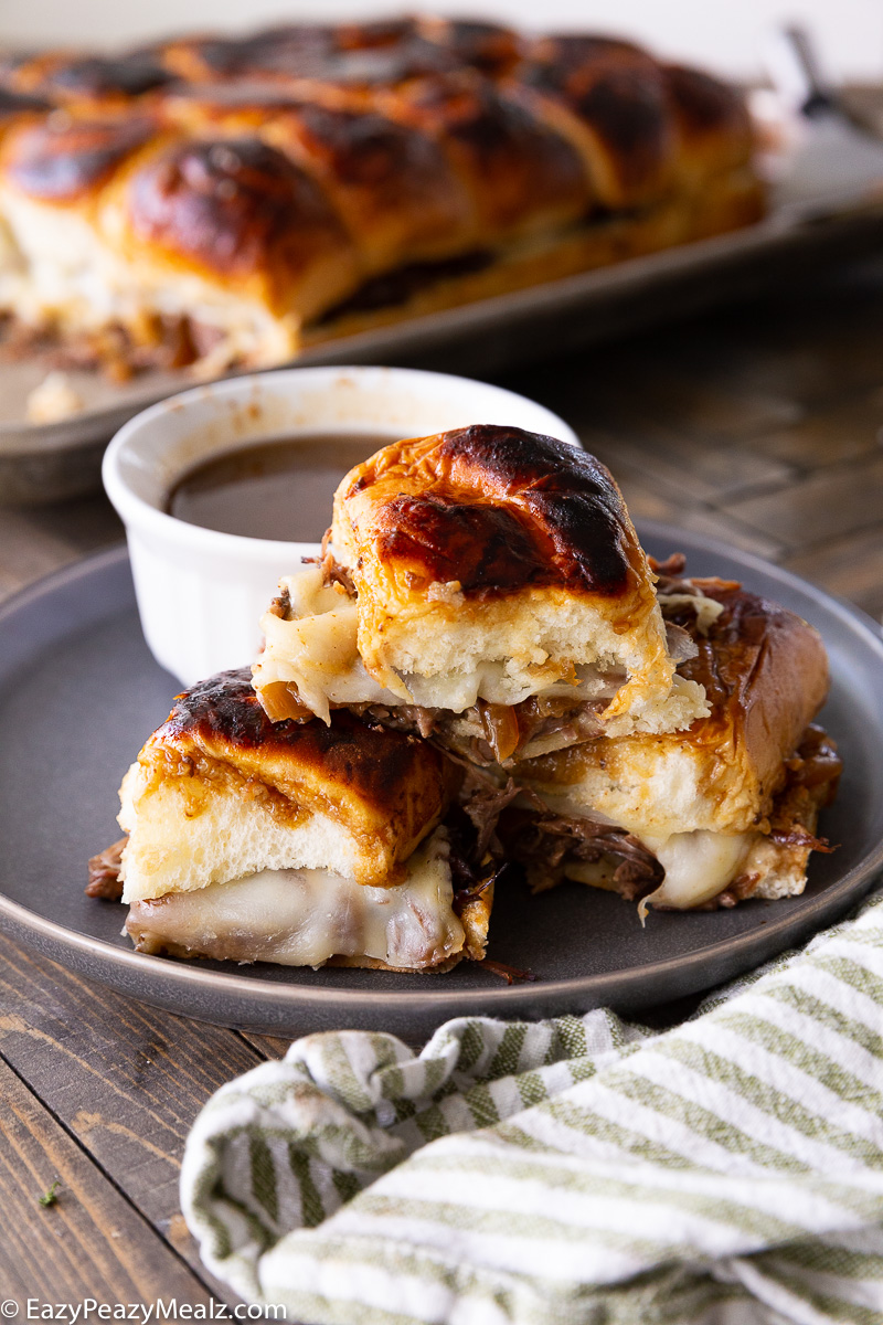 A plate full of french dip sliders made in the slow cooker