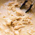 A crockpot full of slow cooker salsa verde queso chicken