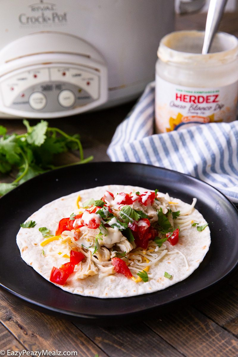 Slow Cooker Salsa verde queso chicken can be made into many things.