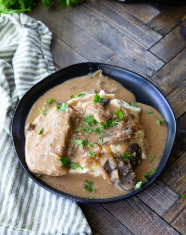 A plate of crockpot creamy mushroom pork chops