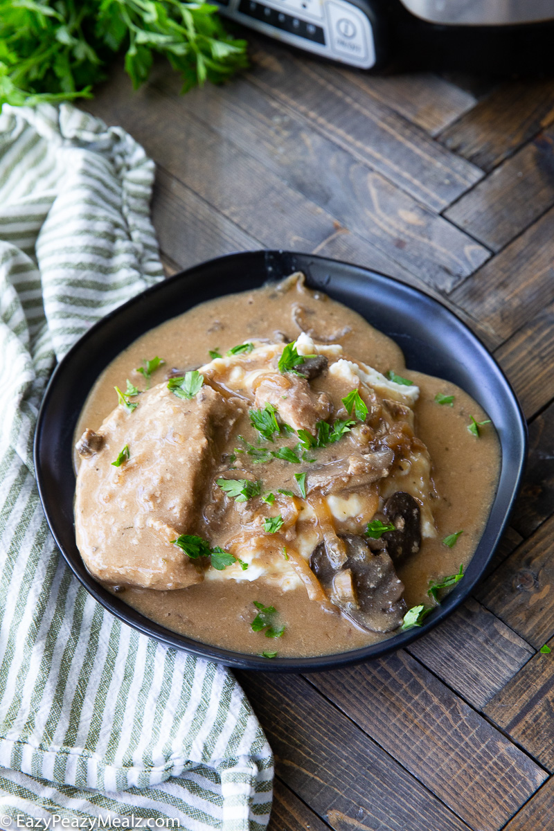 A plate of crockpot creamy mushroom pork chops