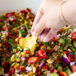 A bowl of lentil cowboy caviar being served with chips