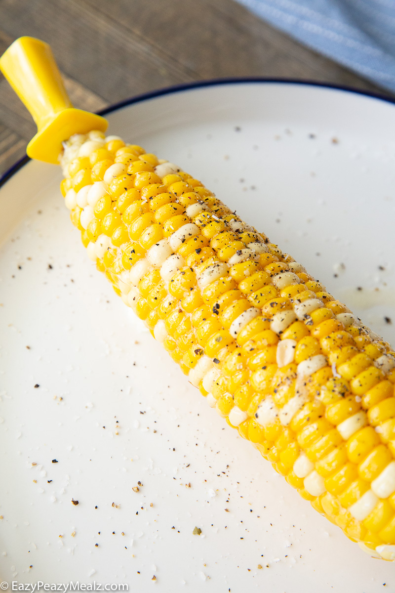 A plate with corn on the cob cooked in the slow cooker.