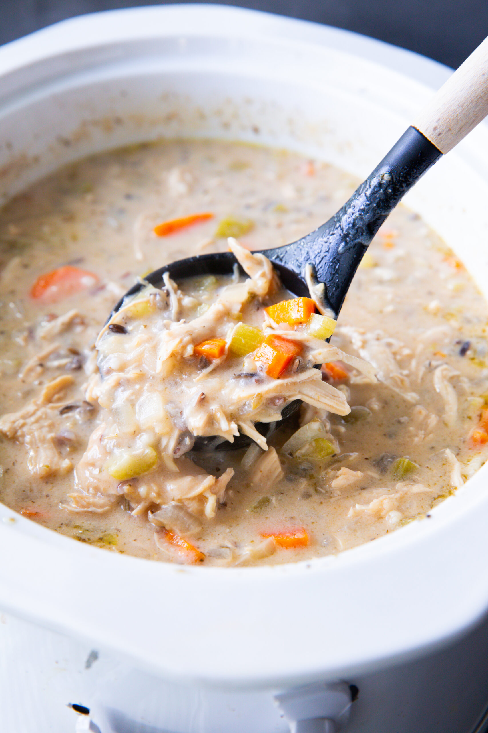 Slow cooker full of chicken and wild rice soup