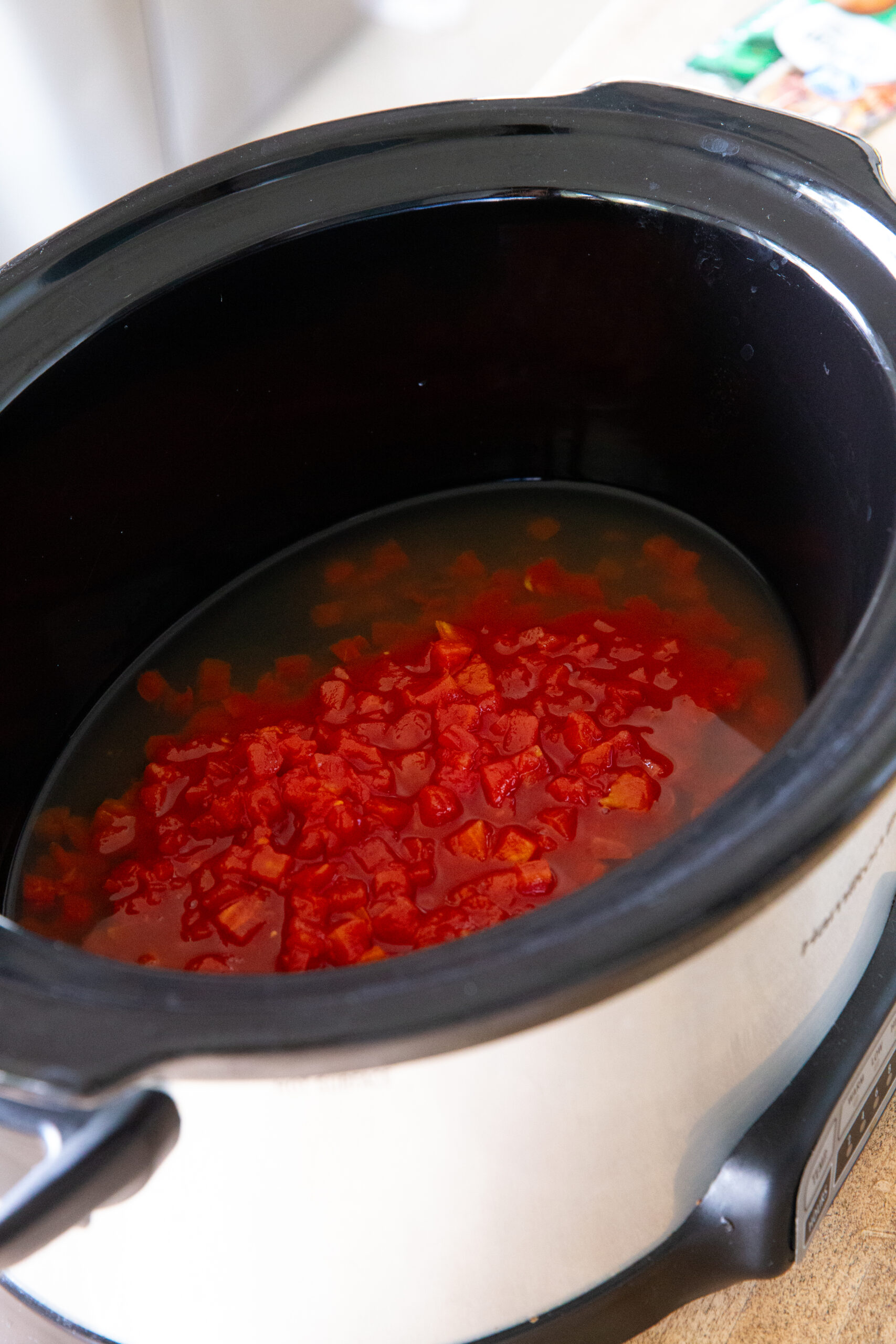 Making creamy crockpot sausage ravioli