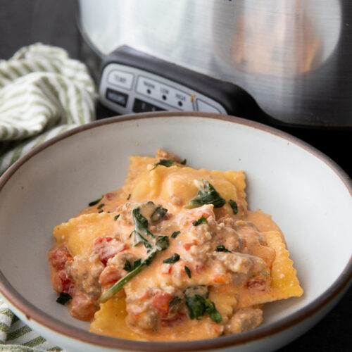 Crockpot creamy sausage ravioli in a bowl