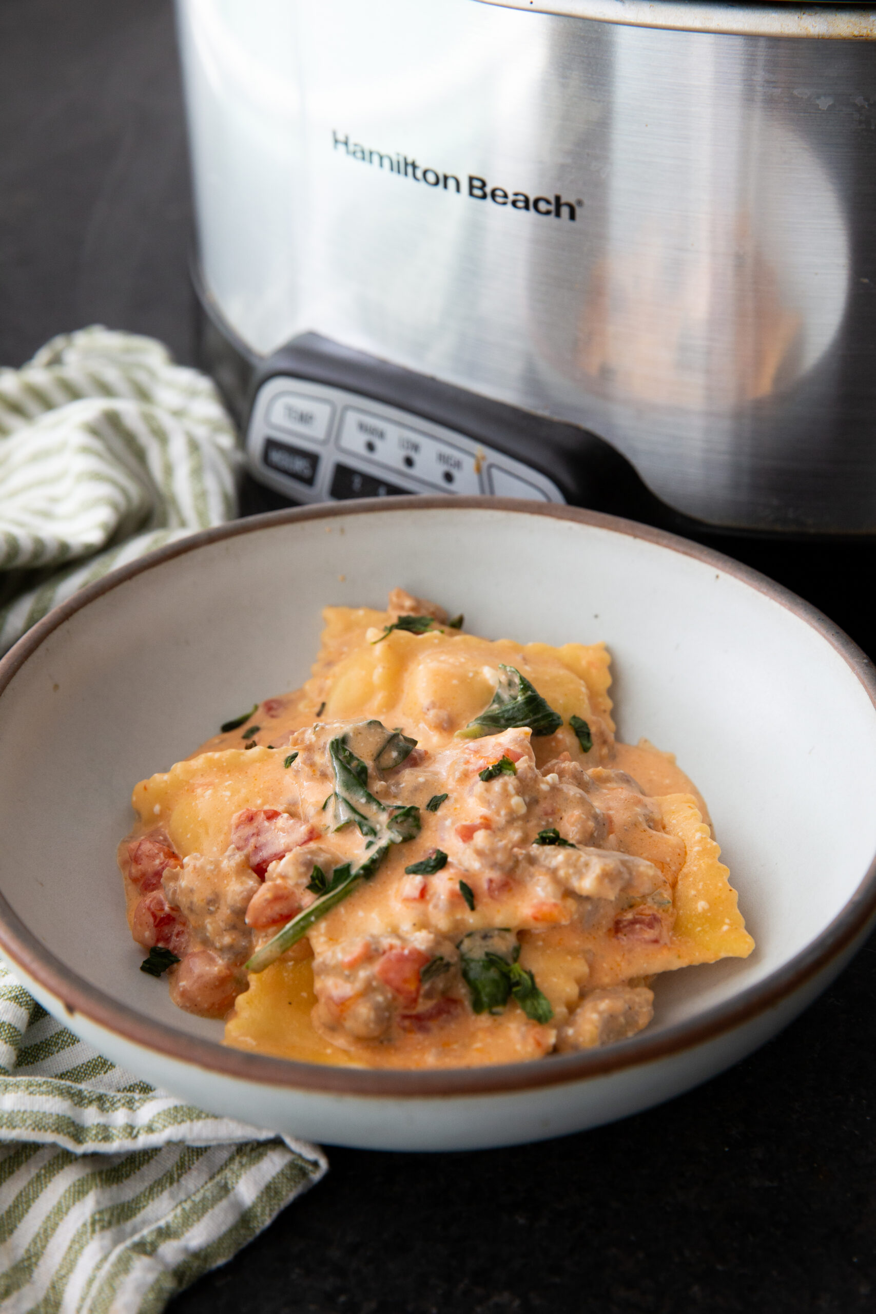 Crockpot creamy sausage ravioli in a bowl