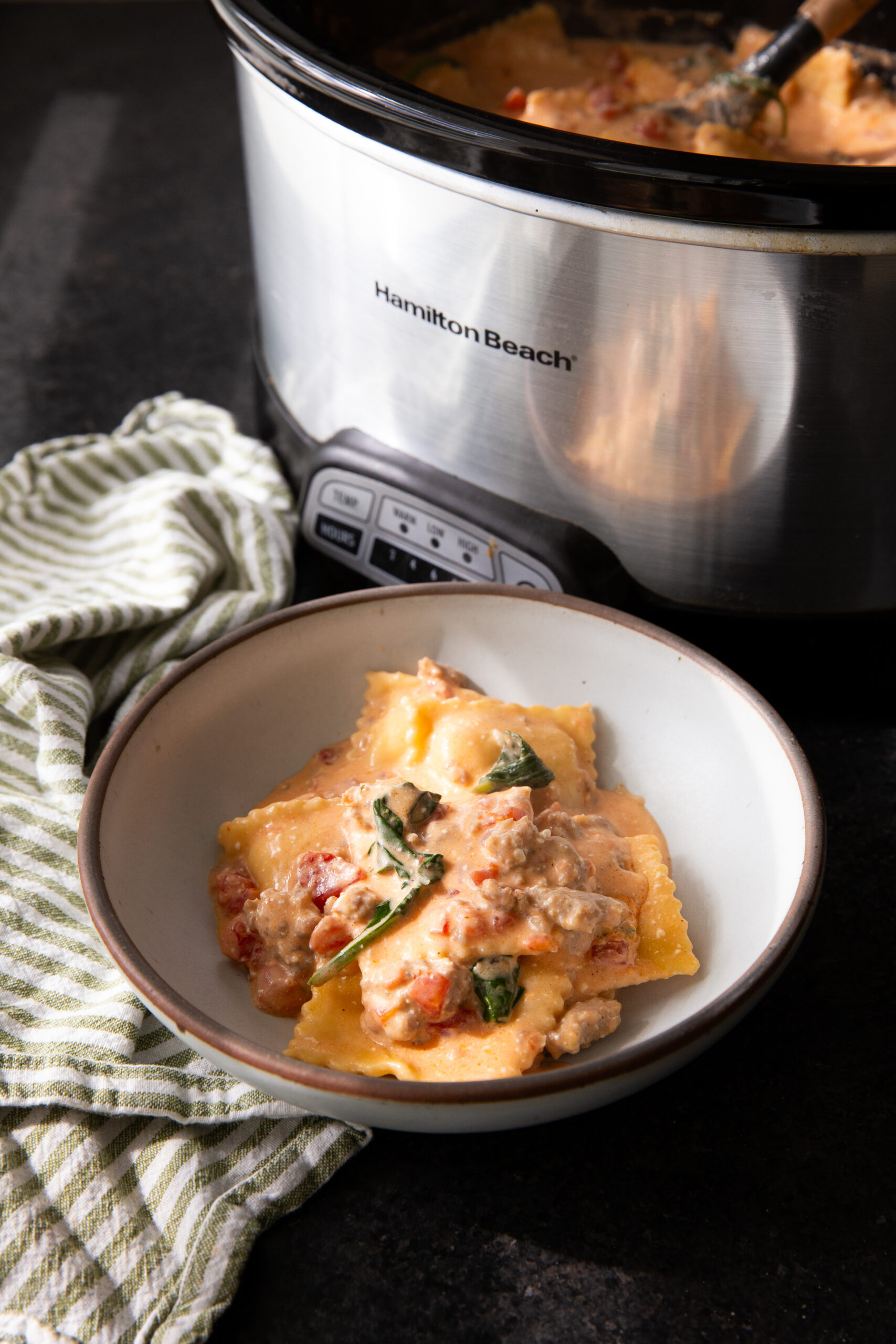 Slow cooker sausage ravioli in a creamy sauce. 