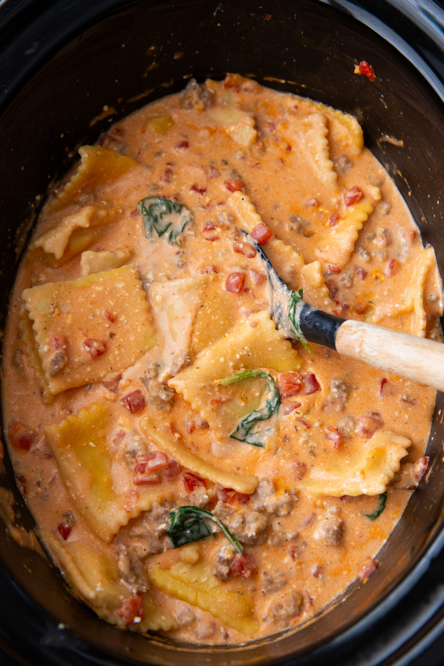 Making a crockpot full of creamy sausage ravioli