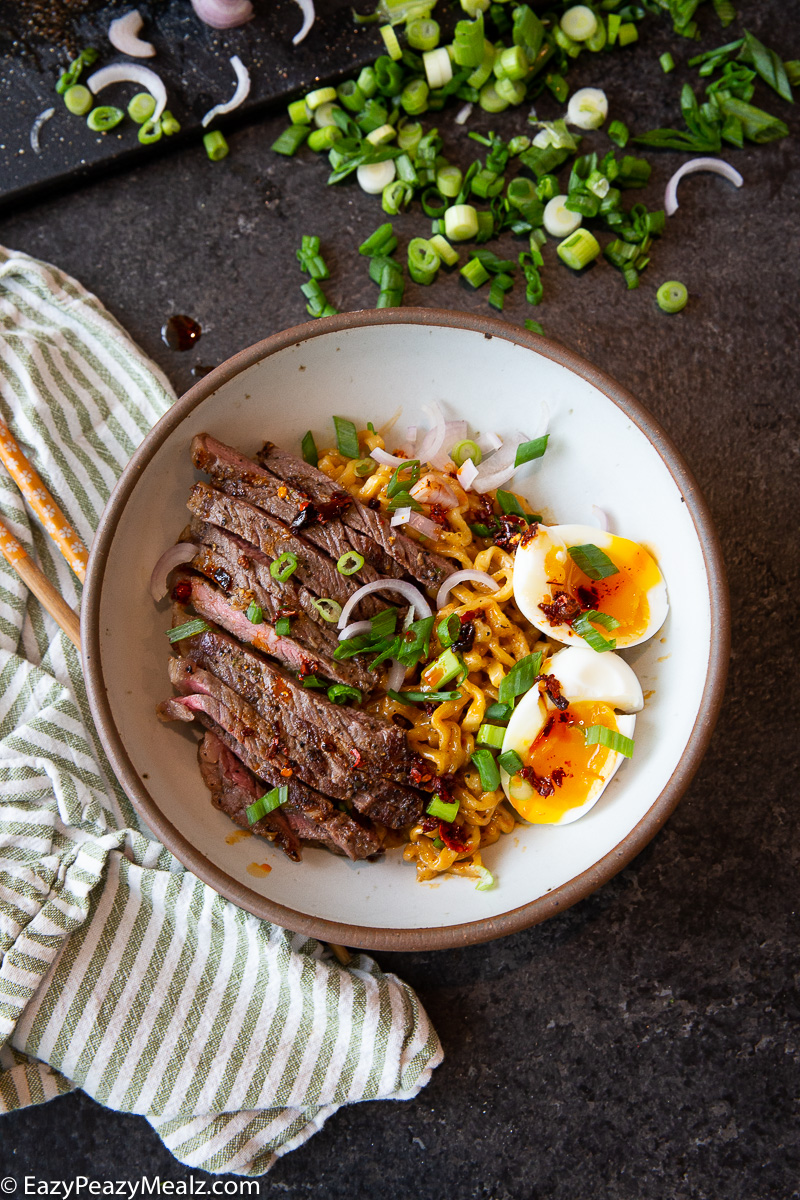 A bowl of garlic butter steak cheesy ramen