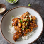 Slow cooker cashew chicken garnished with green onion