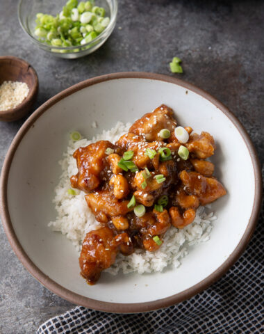 Slow cooker cashew chicken garnished with green onion