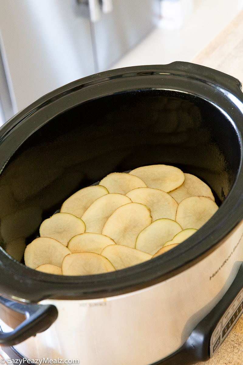 Layers of potatoes in the slow cooker for scalloped potatoes